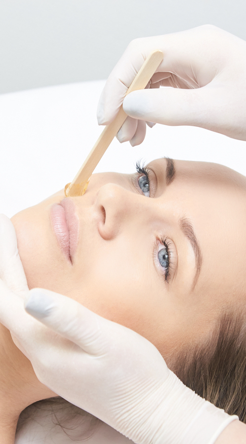 Waxing woman leg. Sugar hair removal. laser service epilation. Salon wax beautician procedure.